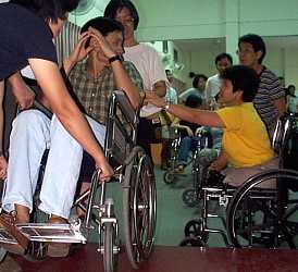 Judy patiently provided step-by-step coaching to the facilitators on how to safely help a wheelchair-bound person get down a curb.